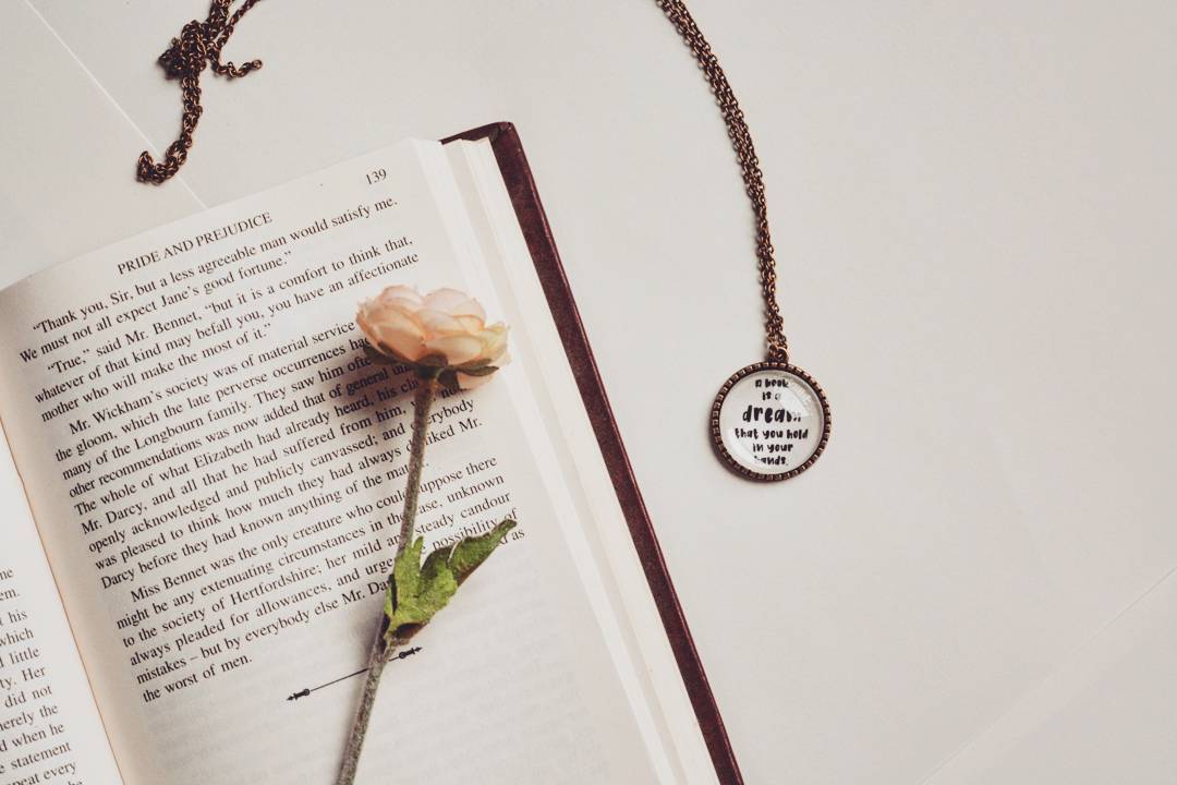 A book is a dream that you hold in your hands - Neil Gaiman Quote Pendant