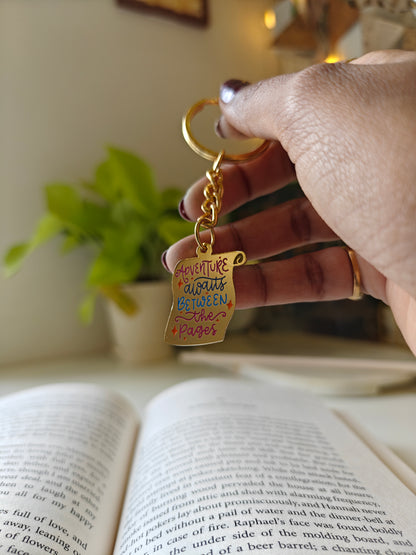Adventure awaits between the pages - Bookish Enamel Keychain