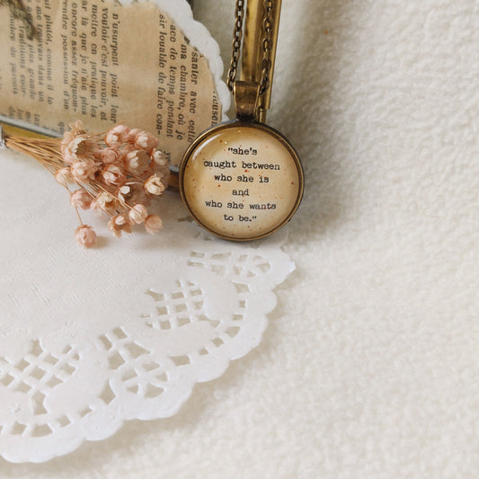 "She's caught between..."  Quote Pendant