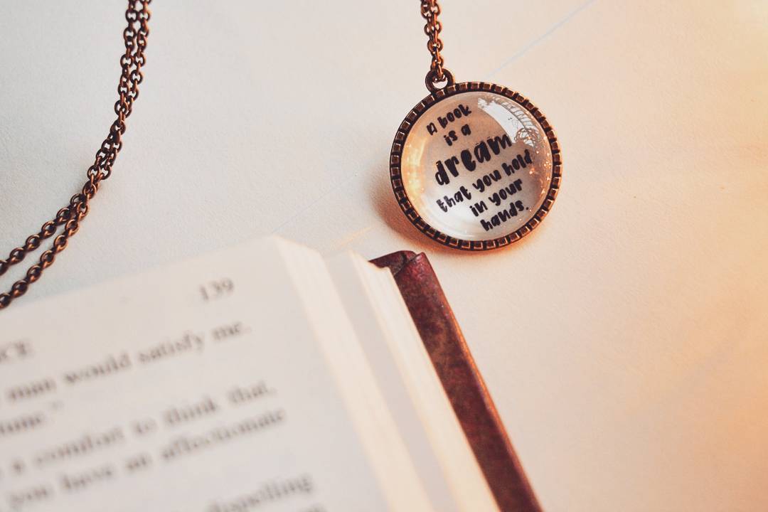 A book is a dream that you hold in your hands - Neil Gaiman Quote Pendant